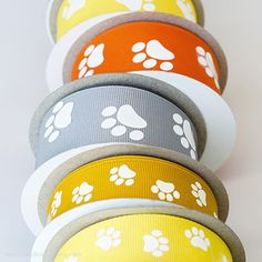 five different colored dog paw print grosch ribbons