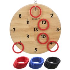 a wooden clock with red, blue and black rings hanging from it's sides