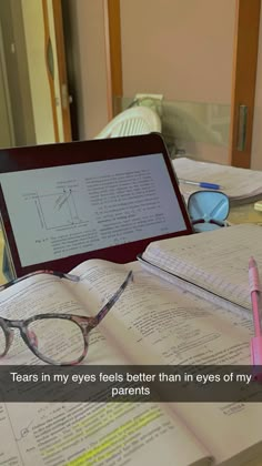 an open laptop computer sitting on top of a desk next to glasses and books with text reading tears in my eyes feels better than in eyes