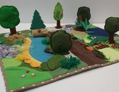 this is an image of a play mat made to look like a landscape with trees and rocks