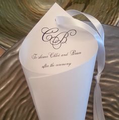 a close up of a paper bag with a ribbon on it's side and an envelope that says, to whoever called and braam after the ceremony