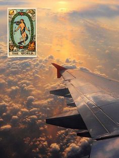 an airplane wing with the image of a woman on it's side and clouds in the background