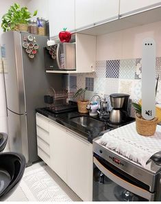 a kitchen with stainless steel appliances and white cabinets