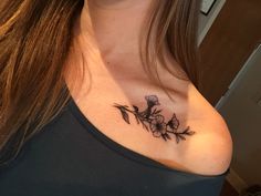 a woman with a flower tattoo on her chest