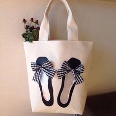 a white bag with black and white shoes on it