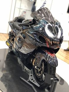 a shiny motorcycle is on display in a showroom