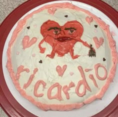 a cake with two hearts and the words cardo written on it in pink icing