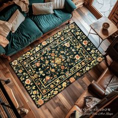 an overhead view of a living room with a green couch and rug on the floor