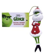 the grinch christmas ornament is hanging from a keychain with a card attached to it