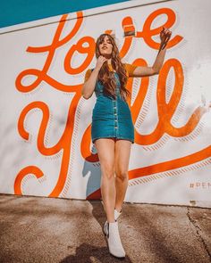 a woman standing in front of a pepsi advertisement