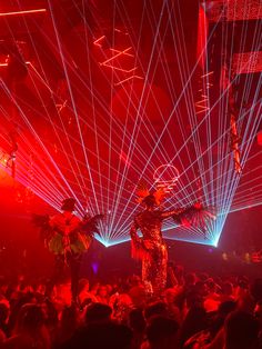 a person standing on top of a dance floor in front of red and blue lights