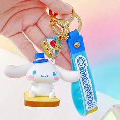 a person holding a toothbrush and keychain with a small animal on it