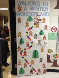 a bulletin board decorated with gingerbreads and people walking in a winter wonderland theme