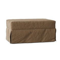 a brown ottoman cover sitting on top of a white floor