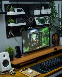 a computer monitor sitting on top of a wooden desk next to a keyboard and mouse