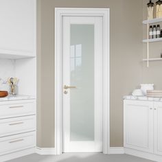 a kitchen with white cabinets and an open door