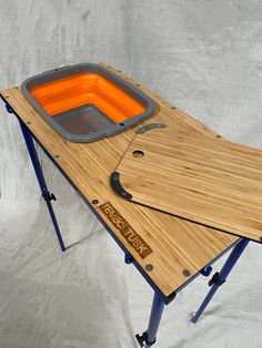 We have incorporated a collapsible sink into our Camp Table. The Basin Table can be used by itself or with our existing camp table by matching the hooks and hoops at each end of the tables. The tables can be hooked together either side by side or end to end. The basin colors are random and might not be exactly as pictured. TemboTusk has designed a beautiful, functional Camping Basin Table. The table is designed to fit into most storage drawer systems or other limited space environments. The Tabl Camp Table, 1000 Lifehacks, Bamboo Plywood, Suv Camping, Utensil Storage, Mini Camper, Camper Life, Camping Table, Camp Kitchen