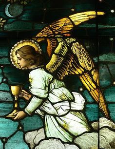 a stained glass window with an angel holding a cup in it's hand and kneeling on a cloud