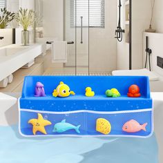 a bath tub filled with toys in a bathroom