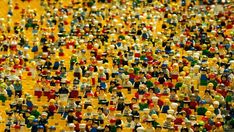 a large group of toy figurines are arranged in the shape of small people