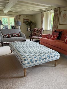 a living room with couches and chairs in it