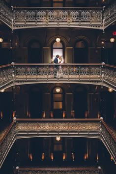 two people standing on the balcony of a building