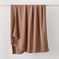 a brown blanket hanging on a clothes line