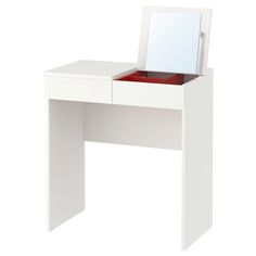 a white dressing table with a mirror on it's top and drawers underneath the drawer