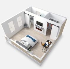 an overhead view of a bedroom and living room in a home with white walls, hardwood floors, and open kitchen