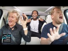 three men sitting in the back of a car talking on their cell phones and laughing