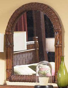 a mirror sitting on top of a wooden dresser