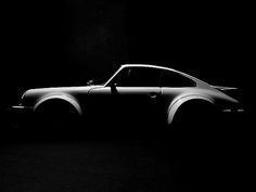 a black and white photo of a car in the dark