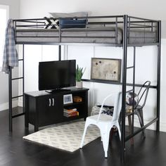 a loft bed with a desk underneath it and a tv on the bottom shelf below