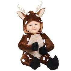 a little boy dressed in a deer costume