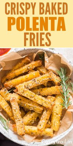 crispy baked polenta fries in a bowl with rosemary sprigs