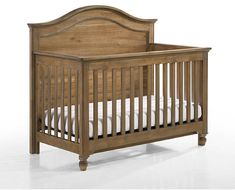 a small wooden crib with white sheets on the bottom and bottom bed, against a white background