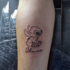 a small tattoo on the leg of a person with an animal in it's hand