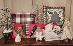 christmas pillows and other decorative items on a table