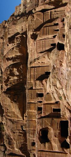 the side of a cliff face with holes in it