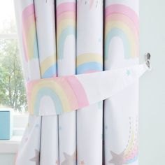 the curtains are decorated with rainbows and stars