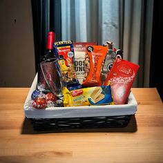 a basket filled with snacks and condiments on top of a wooden table