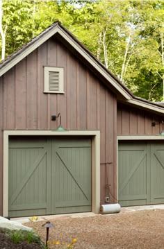 two garages in front of a wooded area