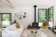 a living room filled with furniture and a fire place in the middle of a room