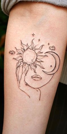 a woman's arm with a sun and moon tattoo on the left side of her body