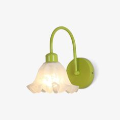 a green wall light with a white glass shade on it's arm and the bulb turned off