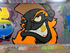 graffiti on the side of a building with an angry looking animal wearing a cowboy hat