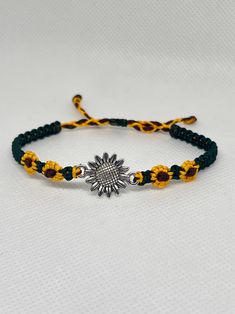 Cute macrame bracelet with a sunflower charm and braided sunflowers in a bright golden color, a leafy green color in between and your choice of knotted center or beaded center. Perfect as an accessory for spring and summer. The bracelets are adjustable with a sliding knot, so it can easily be taken on and off. I make it to order, so let me know your wrist size in the "personalization" tab, so I can make the perfect size for you. The standard size is about 9" long for most bracelets. Colors may vary depending on the screen you are using, so the color might be slightly different in real life. Adjustable Yellow Braided Bracelets As Gift, Adjustable Braided Bracelet Jewelry, Casual Braided Beaded Bracelets As Gift, Adjustable Braided Jewelry Bracelet, Casual Braided Beaded Bracelets For Gift, Casual Braided Bracelet Jewelry, Casual Braided Bracelet, Yellow Adjustable Friendship Bracelets As Gift, Adjustable Yellow Bohemian Friendship Bracelets