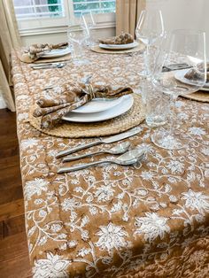 the table is set with silverware and place settings