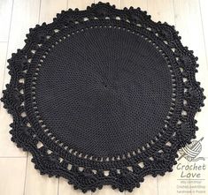 black crochet doily on white wood floor