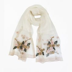 White embroidery scarf - Made in 40% silk, 60% wool. Scarf size measures 70cm in width and 192cm in length. Versatile and stylish, this scarf effortlessly elevates your ensemble, whether draped over your shoulders or intricately tied. Silk Shawl Scarves For Spring, Silk Shawl Scarf For Spring, Elegant Embroidered Spring Scarves, Elegant Embroidered Scarves For Spring, Elegant Embroidered Silk Shawl Scarf, Elegant Embroidered Silk Shawl, Elegant Silk Shawl Scarf For Spring, Elegant Silk Shawl For Spring, Spring Silk Cream Scarves